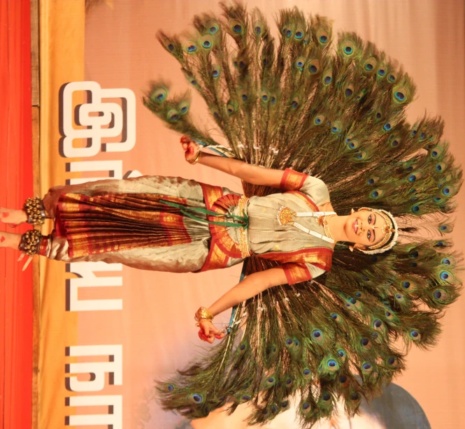 a woman wearing a costume with peacock feathers