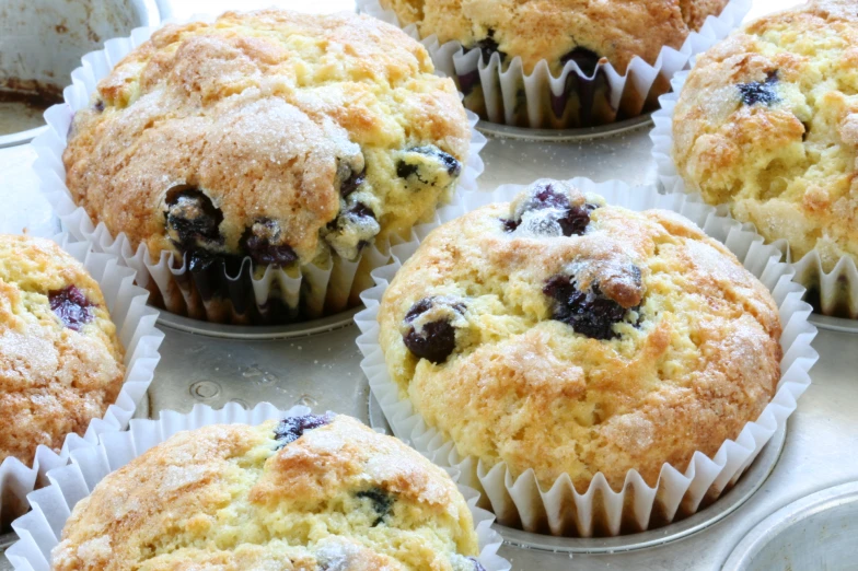 many muffins are lined up together on the table