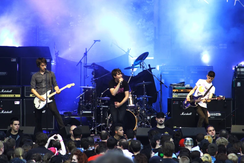 a group of men standing on top of a stage