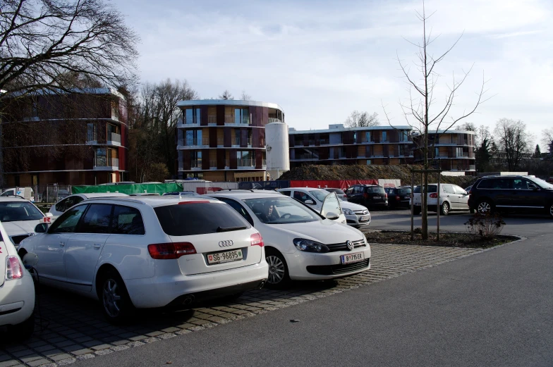 a group of cars are parked on the side of the road