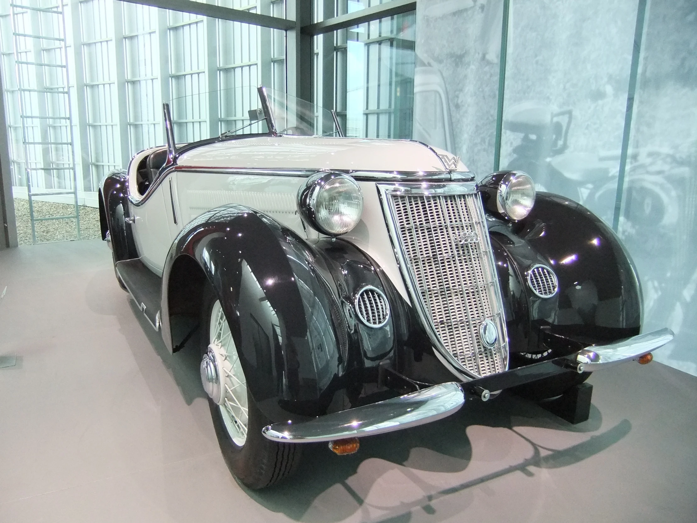 a classic car parked inside of a garage