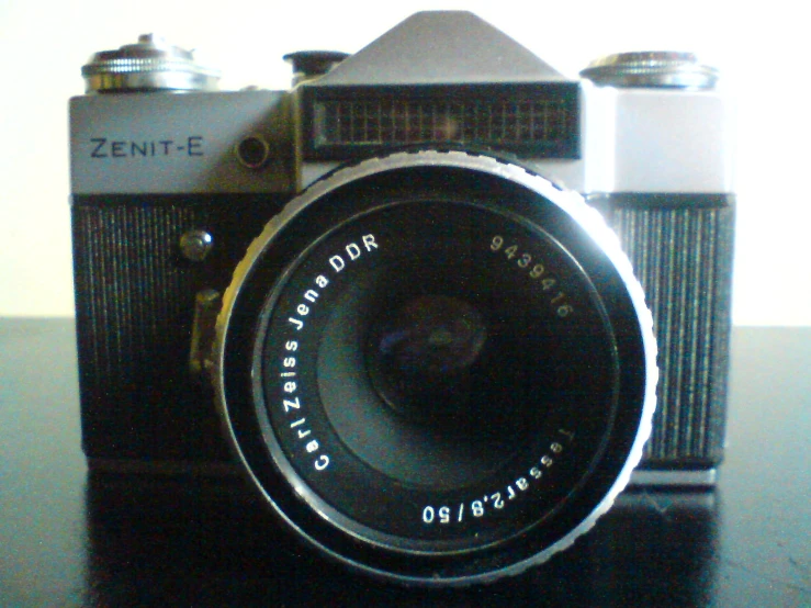 a silver and black camera on a table