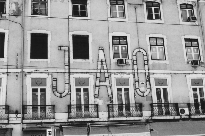 an old building with multiple windows and a clock on the side