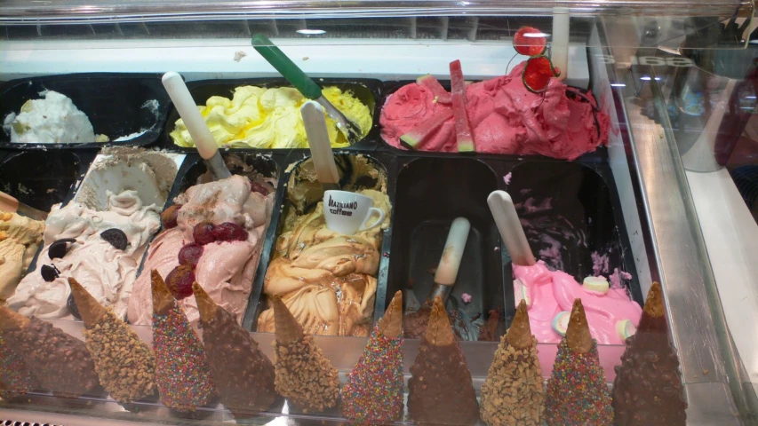 a display case of ice creams with different flavors and colors