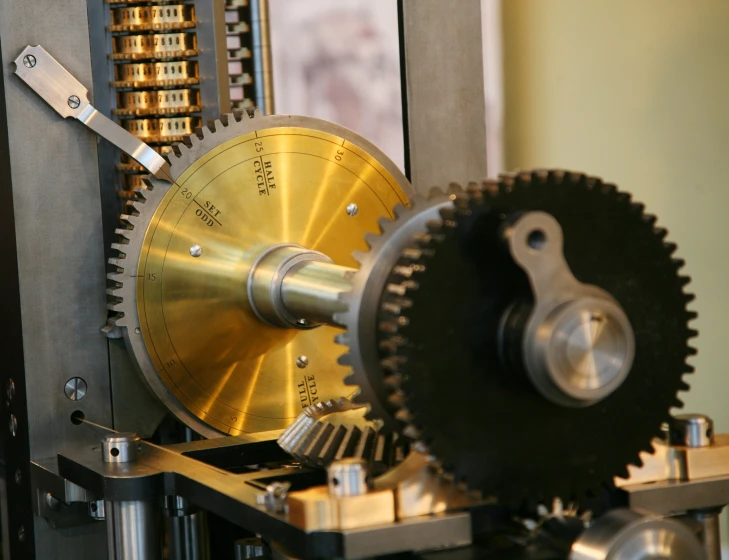 a clock face with gold and black gears