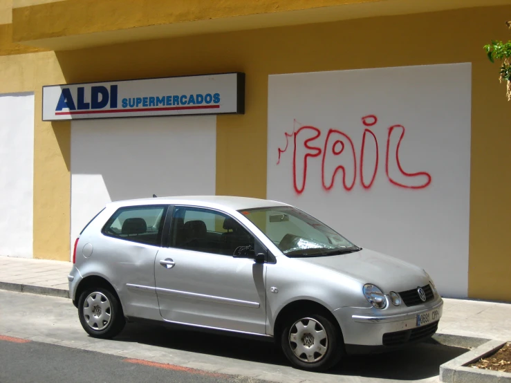 a silver car parked on the side of the street