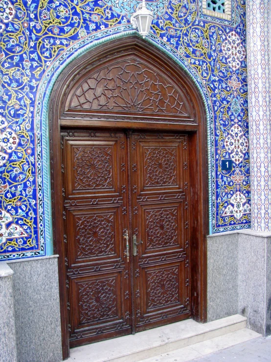 an oriental style wooden door is on a building