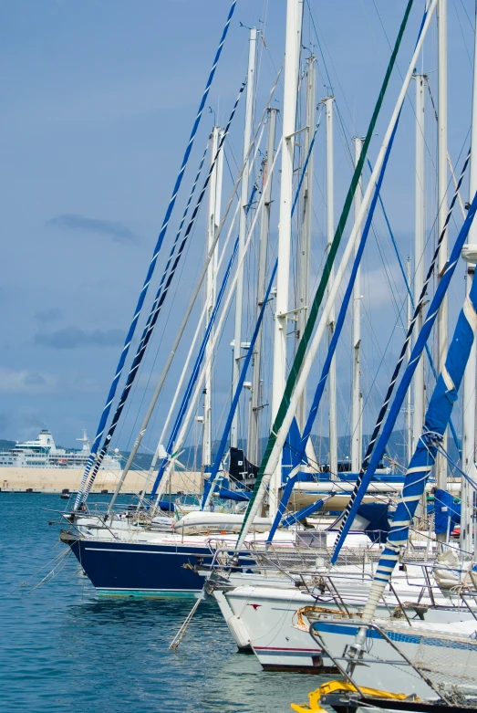 several sailboats docked next to each other in the water