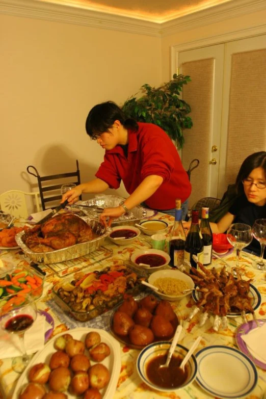 the woman is in a red dress and has one hand up on the food she is holding