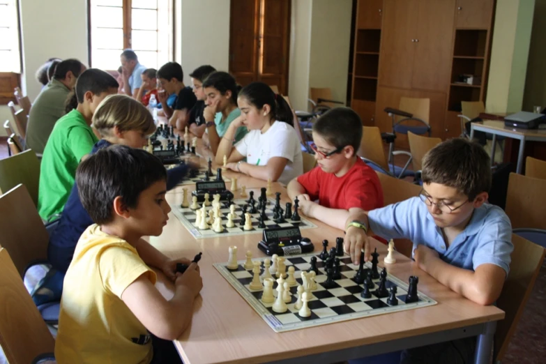 a bunch of boys playing chess together