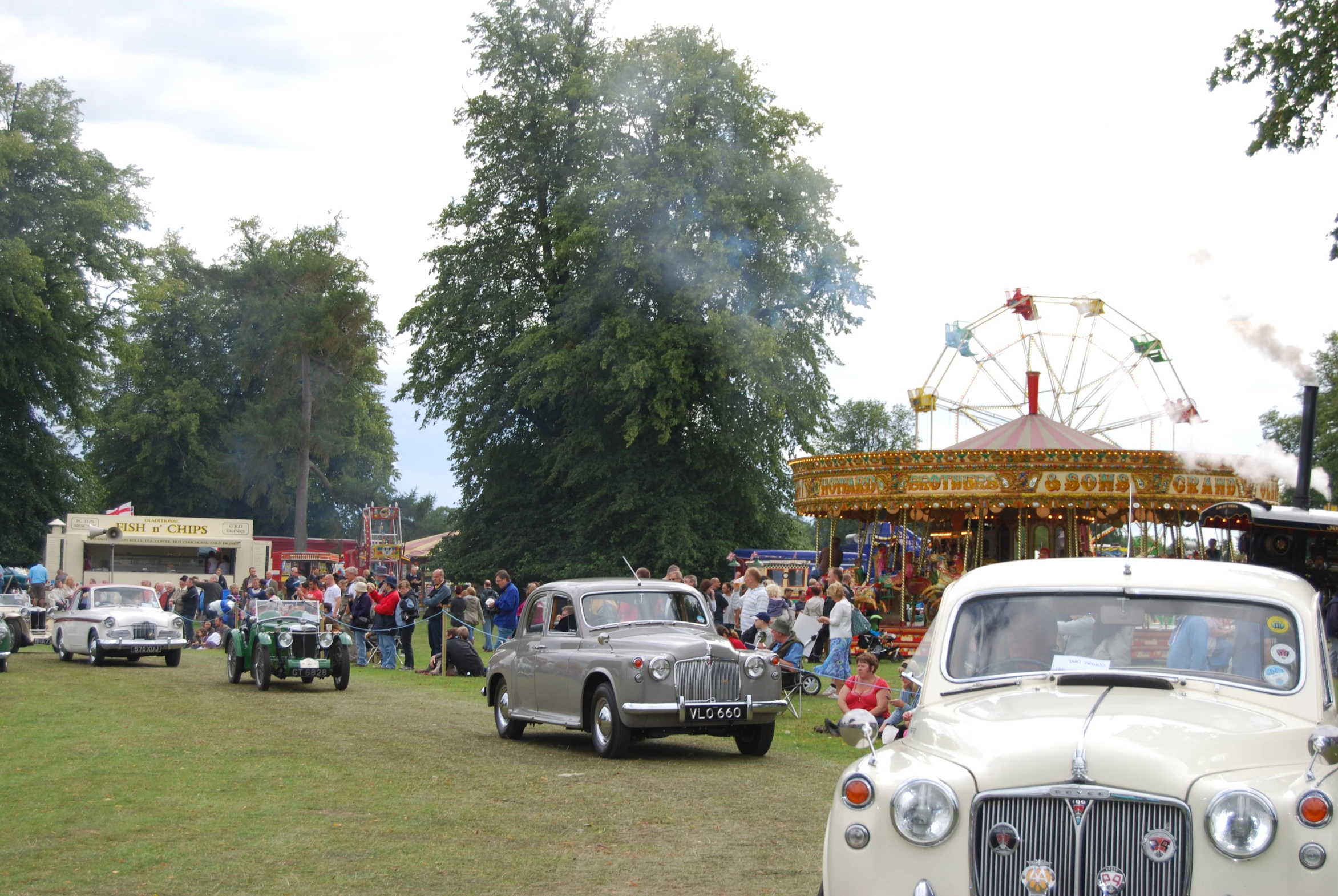 an old car in a parade with others watching