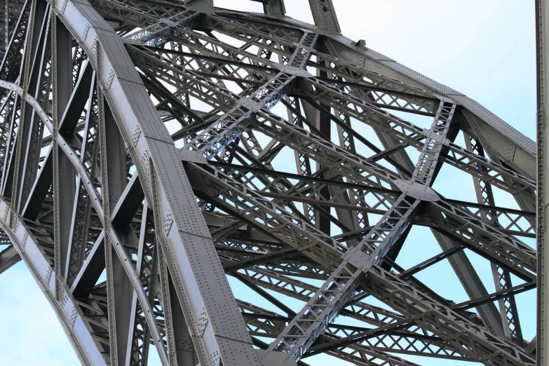 the steel structure is intricately detailed against the blue sky