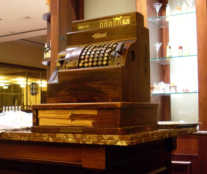 an old fashioned cash register machine on a counter in a bar