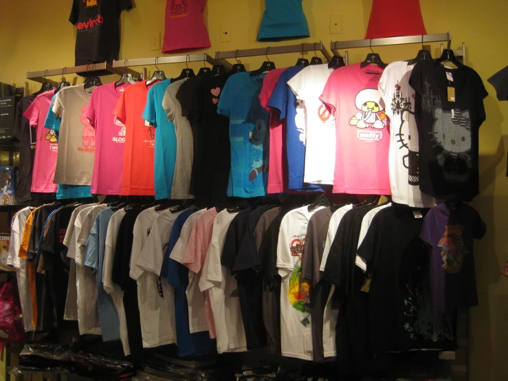 a rack of t - shirts is displayed in a store