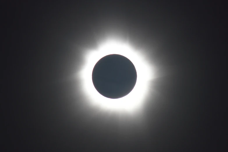 the moon eclipse during the day showing a halo around it