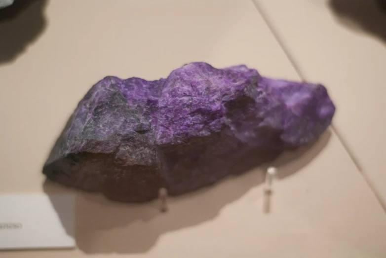 a purple rock on display at a museum