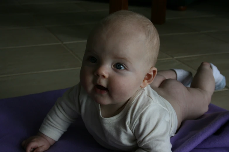 a baby on a blanket on the floor