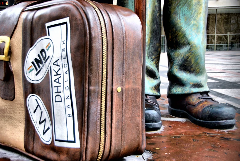 a person stands next to a piece of luggage