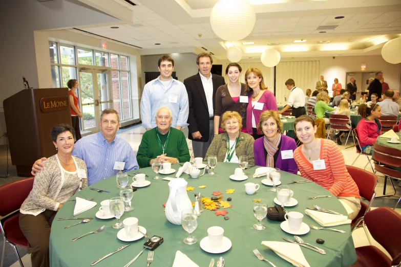 a group of people sitting around a table eating food