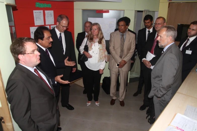 a group of people that are standing in a room