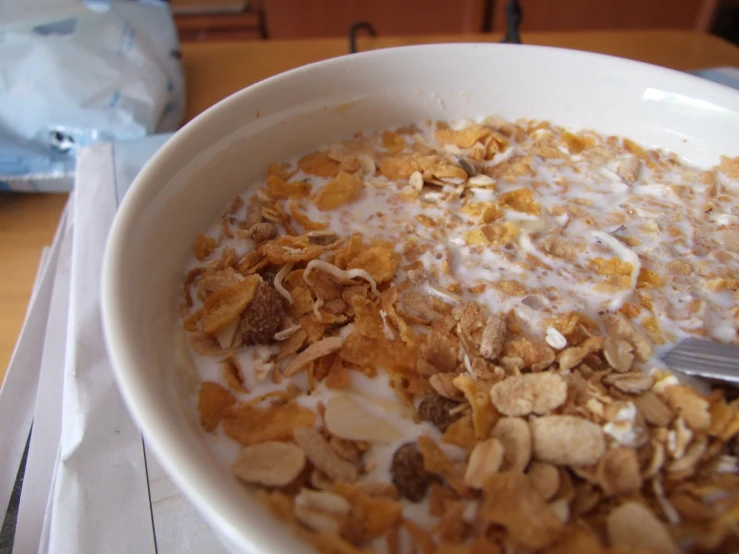 an oatmeal bowl full of cereal and milk