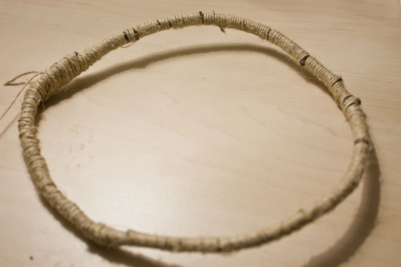 an old rope with an oval shaped bead on top of it