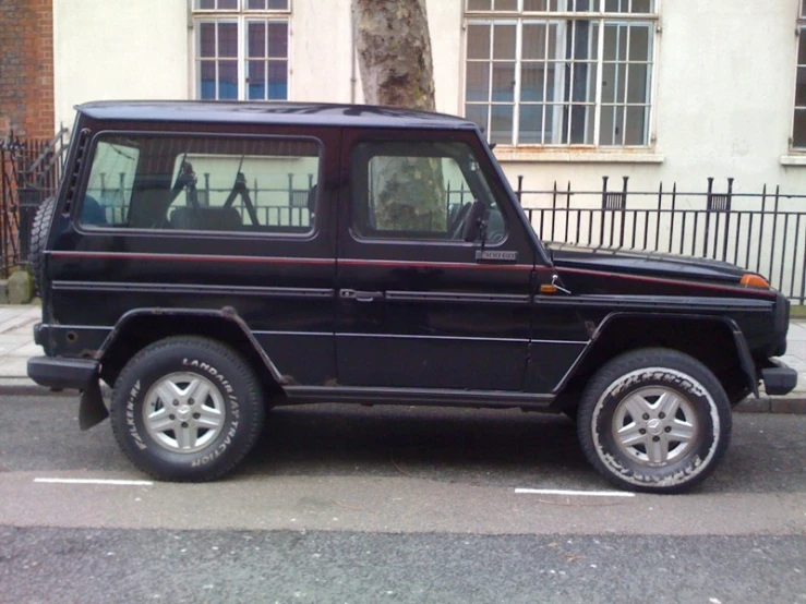 an black vehicle parked on a city street