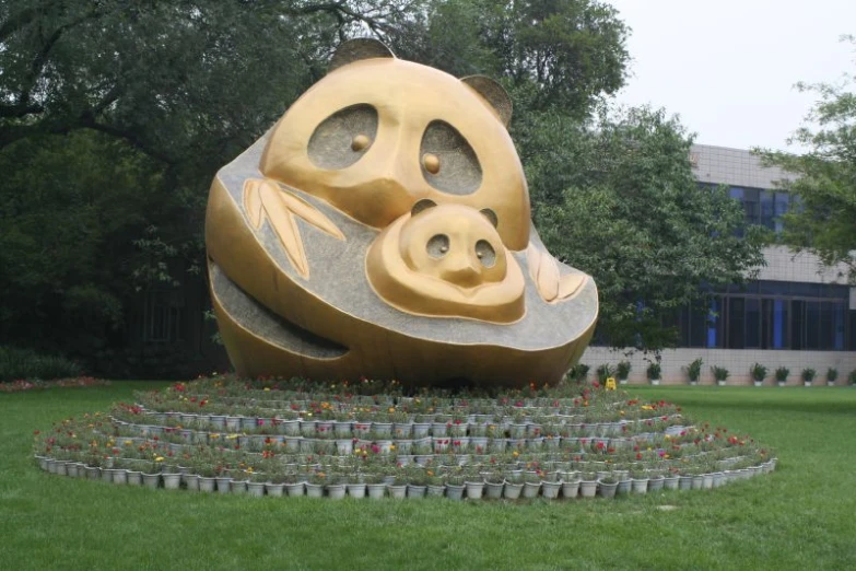 a statue with a panda's head and a baby laying in a circular