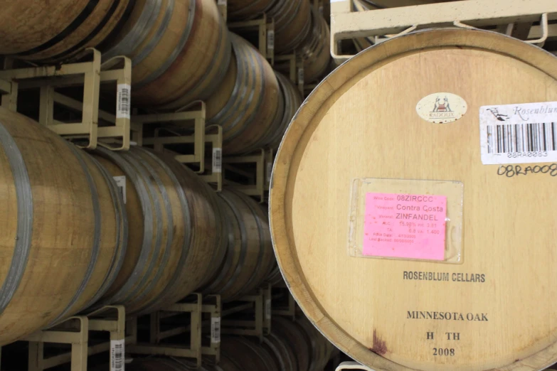 a bunch of wooden barrels stacked next to each other