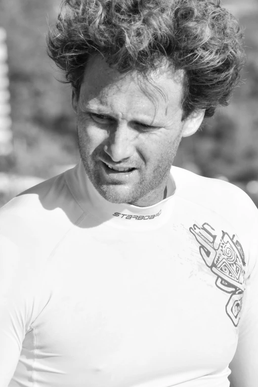 black and white po of a man wearing a wetsuit