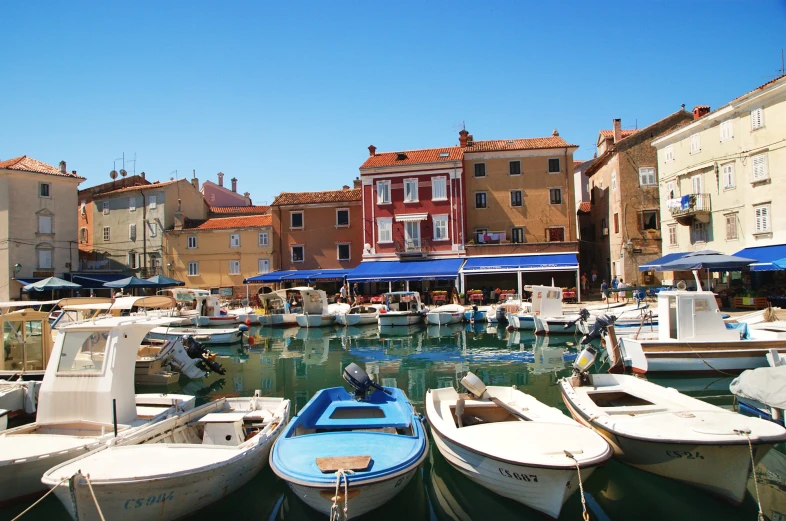 many boats docked on a body of water near a city