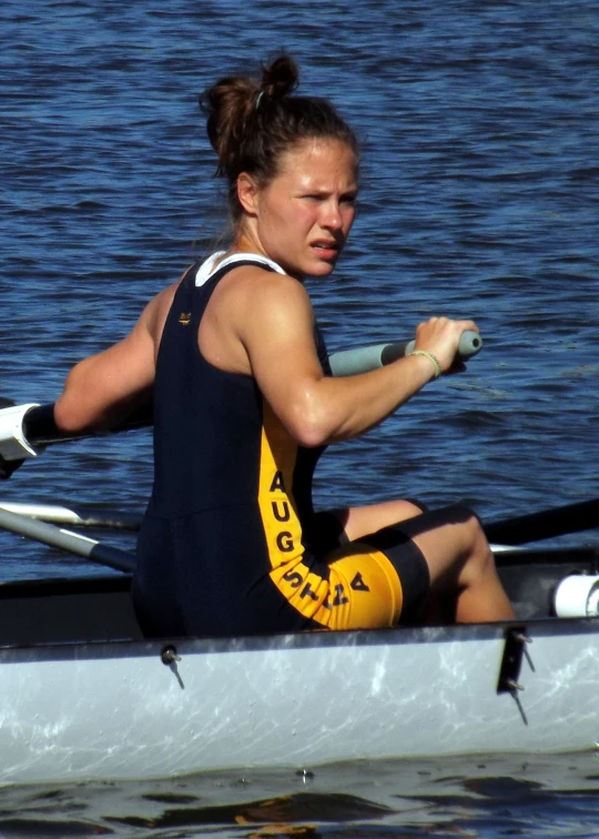 a woman wearing yellow and black attire in a boat