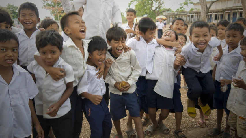 several children in white shirt standing next to each other