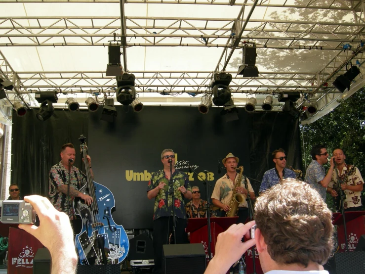 a group of men with guitars on stage