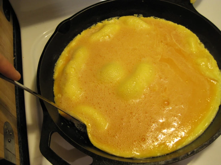 someone is frying some food in a pan