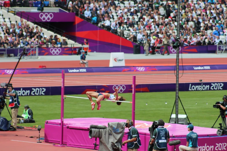 a woman who is jumping over an obstacle