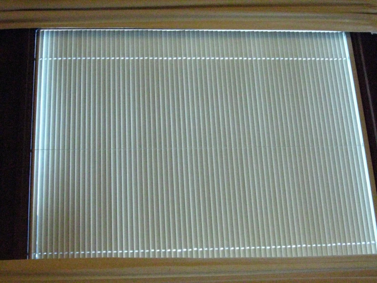 a window with a light and blinds covering the bottom portion of it