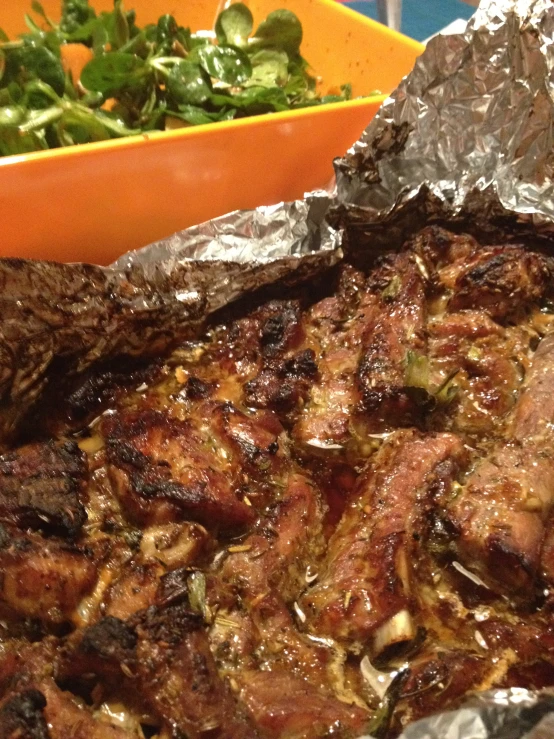 close up of a roast with vegetables in a container