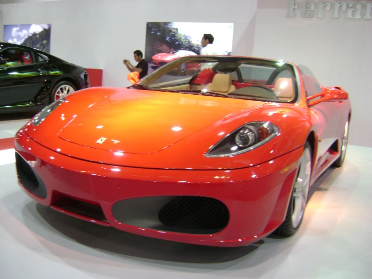 a red sports car on display at the show