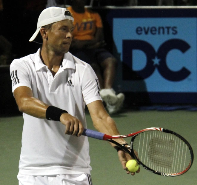 tennis player with racquet playing with ball in air