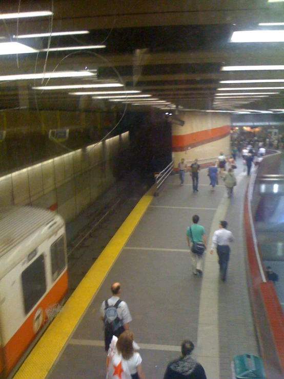 passengers exit a commuter train as it pulls into the station