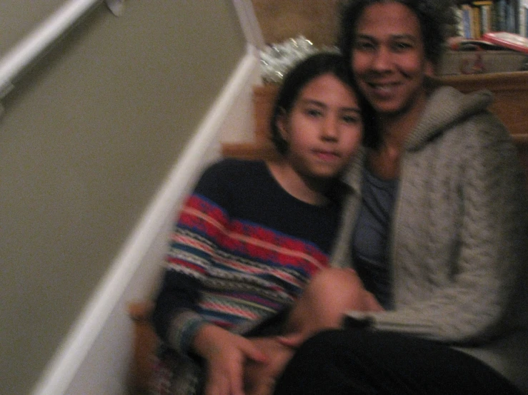 an adult and young child sitting together in a stairwell