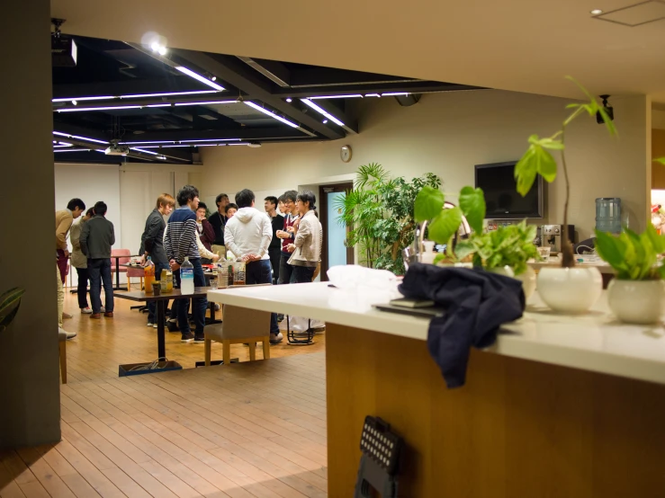 a group of people standing around in a room