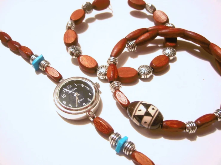 two wooden beads that are attached to a necklace