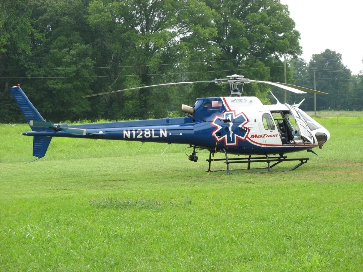 a blue helicopter on a green field with a red and white design