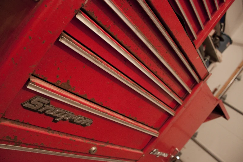 a red locker with a silver shelf underneath it