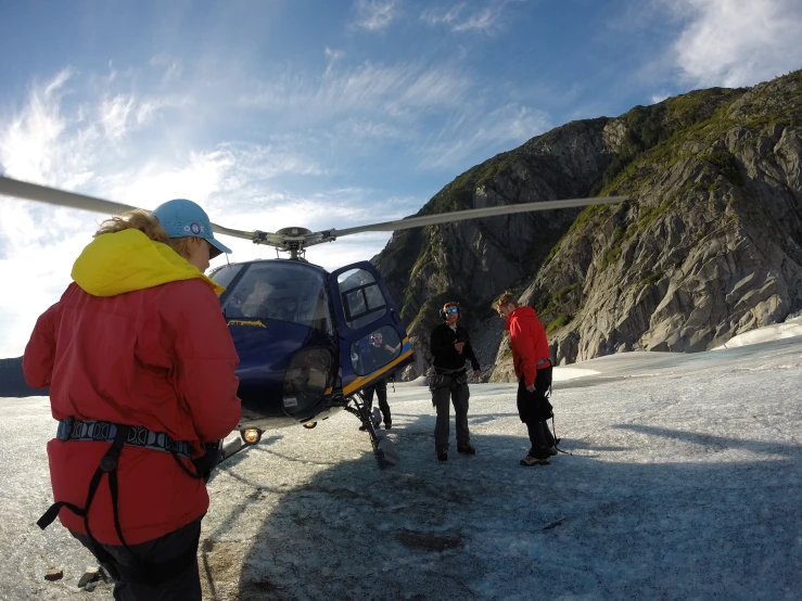 a helicopter is about to land on top of a mountain