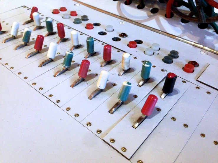 several miniature toothbrushes sitting on top of small pins on a table