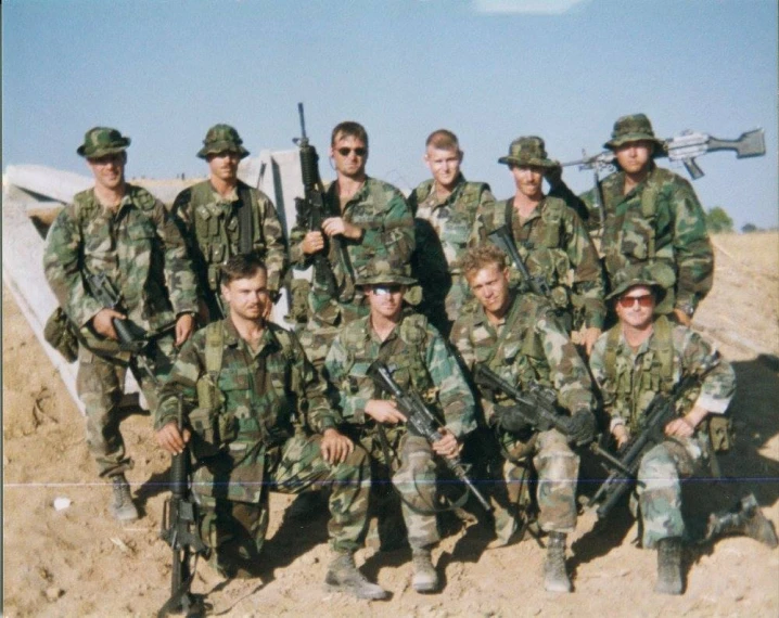 a group of men wearing army uniform posing together