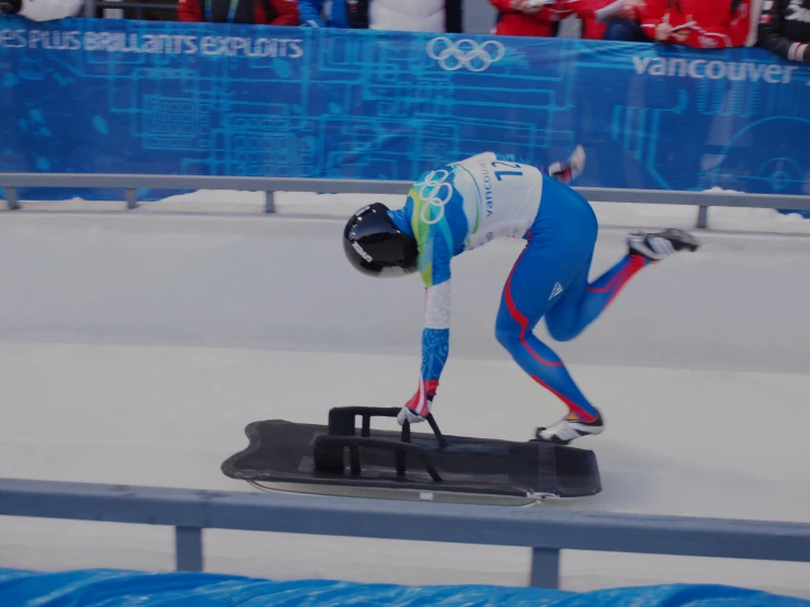 a man skating down a snow slope with one hand on his hip